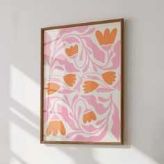 an orange and pink painting hanging on the wall