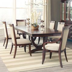 a dining room table with chairs around it