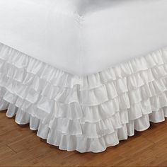 a white bed skirt with ruffles on it