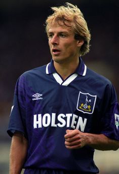 a young man in a soccer uniform on the field