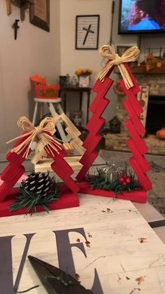 two wooden christmas trees on top of a table