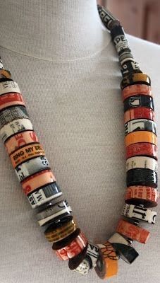 a woman wearing a white shirt and a necklace made out of different types of books