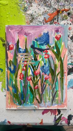 an abstract painting with flowers and birds on it's easel in front of a green wall