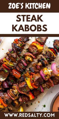 steak kabobs are served on skewers with sauces and garnishes