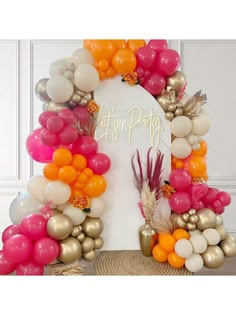 an arch made out of balloons with the words let's party written on it