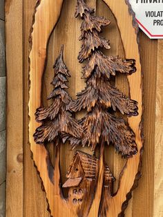 there is a wooden plaque with trees on it