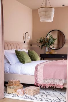 a bedroom with pink walls and white bedding