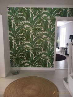 a living room with green wallpaper and rug