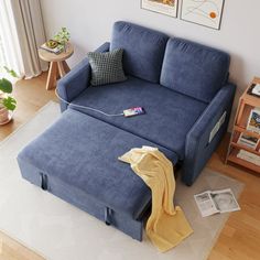 a blue couch sitting on top of a hard wood floor