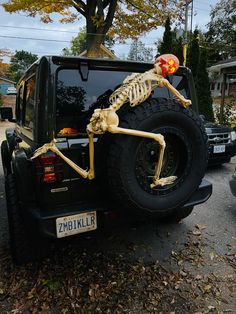 a skeleton sitting on the back of a truck