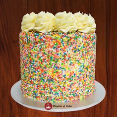 a birthday cake with sprinkles and white frosting