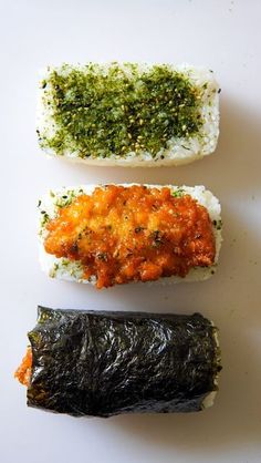 three different types of sushi on a white surface