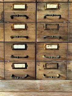 an old wooden drawer with metal handles and knobs