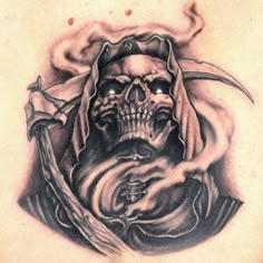 a man's chest with a skull on it and a knife in the middle