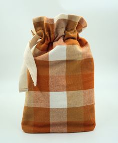 Handmade with care and attention to detail, this hot water bottle cover is the ideal accessory during colder seasons. The orange & ivory brushed cotton buffalo check fabric is both soft and sturdy. This hot water bottle cover is hand made, by me, in my home using professional sewing techniques.  What makes it different than most hot water bottle covers? This hot water bottle cover is fully satin lined and insulated, which means no exposed seams, and longer-lasting heat from your hot water bottle. I choose fabrics that are beautiful and durable, in this case a cozy cotton buffalo plaid.   *NEW UPDATE* Don't have a hot water bottle? Select the option to add natural rubber hot water bottle to go with your new hot water bottle cover! Features: Draw-cord closure: easily insert or remove your st Buffalo Check Fabric, Bottle Covers, Buffalo Check Plaid, Hot Water Bottle Cover, Water Bottle Covers, Exposed Seams, Hot Water Bottle, Check Fabric, Bottle Cover