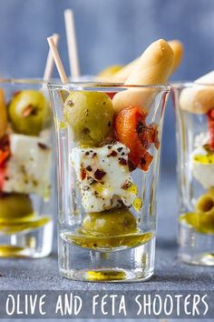 olives and feta shooters in small glasses with toothpicks