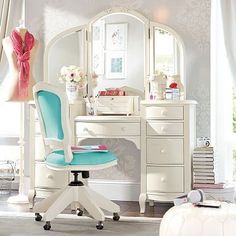 a white desk with a mirror, chair and dresser in a room filled with furniture