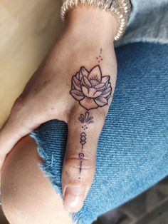 a woman's foot with a flower tattoo on it