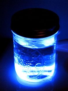 a lit up jar sitting on top of a table