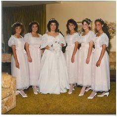 a group of women in white dresses standing next to each other on a carpeted floor