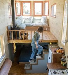 a woman climbing up the stairs in a tiny house