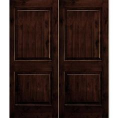 two dark brown doors with wood paneling on each side and one in the middle