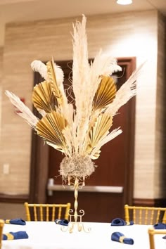 the centerpiece is decorated with gold fan feathers