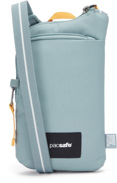 the pacsafe bag in light blue with yellow handles and zippered closures