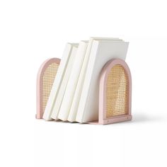 three books are stacked on top of each other in front of a white background with pink trim