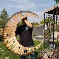 a man standing in front of a large metal object with stars on it's side