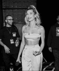 a black and white photo of a woman in a crop top