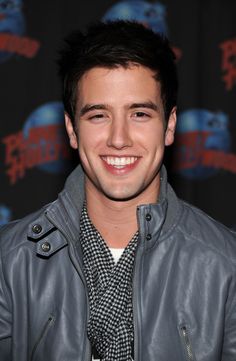 a smiling young man wearing a leather jacket