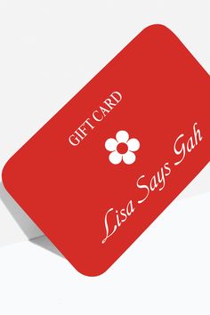 a red gift card sitting on top of a white table