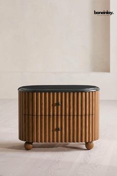 a round wooden table sitting on top of a white floor