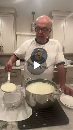 an older man is mixing some food in a bowl on the kitchen counter with a spatula