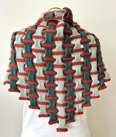 a knitted scarf with red, white and blue strips on it's back