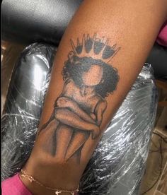 a woman's arm with a tattoo on it and a crown in the middle