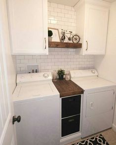 a white washer and dryer sitting next to each other in a room with tile flooring