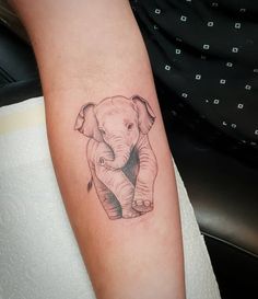 a small elephant tattoo on the arm