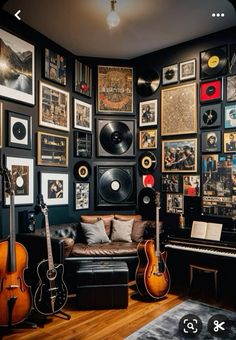 a living room filled with lots of guitars and pictures on the wall next to a couch