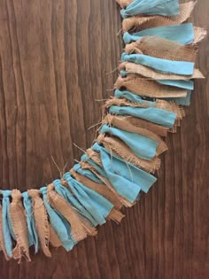 a piece of burlap and jute string on a wooden table with scissors