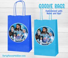 two blue shopping bags with pictures of people on them and balloons in the air behind them