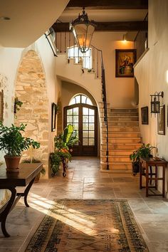 an entry way with stairs and potted plants