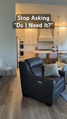 a living room filled with furniture next to a kitchen