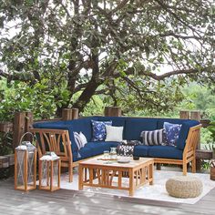 a blue couch sitting on top of a wooden deck