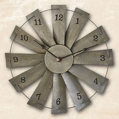 a large metal clock with numbers on it's face in the shape of a sunburst