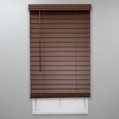 a window with brown blinds in the corner