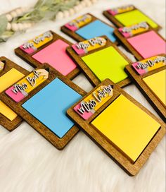 colorful sticky notes are arranged on a white furnishing surface with greenery in the background