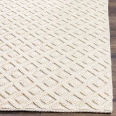 a white rug on top of a wooden floor