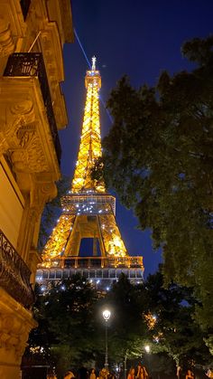 the eiffel tower is lit up at night